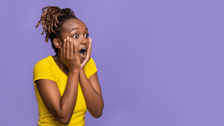 Surprised woman in front of colorful background