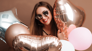 Woman holding balloons