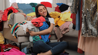 Women holding trendy clothes