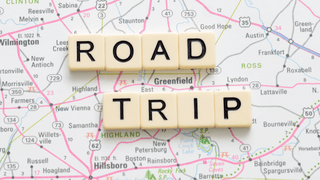 A map with letter blocks that say "ROAD TRIP"