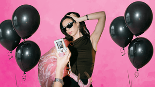 Woman posing at a bachelorette party with balloons