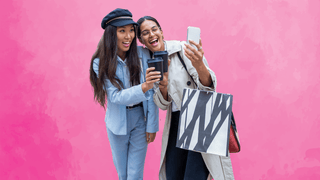 Women holding coffee cups and taking a selfie
