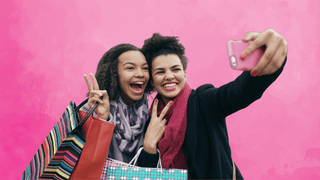 Two women taking a selfie while out shopping