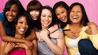 A group of mothers and daughters smiling