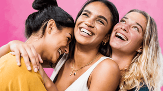 Women smiling and hugging