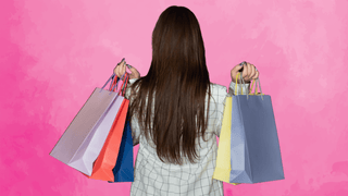 Woman shopping in front of pink background