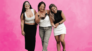 Group of women in front of pink background