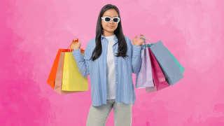 Woman holding shopping bags and posing