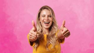 Woman giving two thumbs up and winking