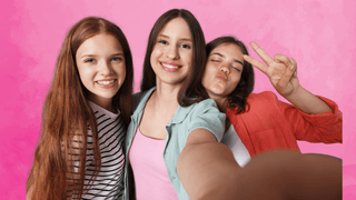 Group of three teenage girls posing for a selfie