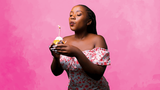 Woman blowing out birthday candle