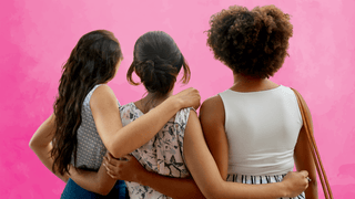 Three women with their arms around each other