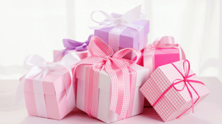 A collection of pink and purple gifts in girly packaging
