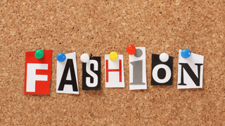 The word "FASHION" pinned to a corkboard