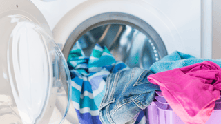 A variety of colorful clothing in a laundry room