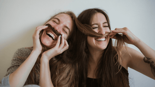 Two women laughing and being silly together