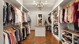 A large walk-in closet with colorful women's clothing