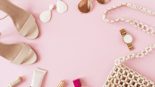 Feminine accessories against a pale pink background