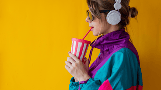 A woman in bright colored 90's fashion