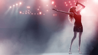 Woman in cute outfit performing on stage