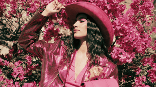 Woman in a vibrant pink outfit with bold pink makeup