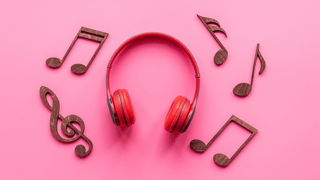 Headphones and music notes on a pink background